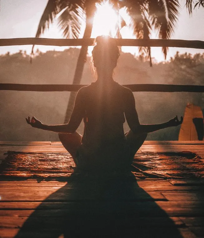 Some one meditating as the sun goes down